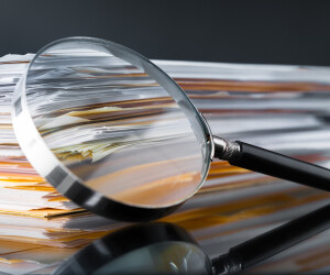Magnifier leaning against a stack of documents