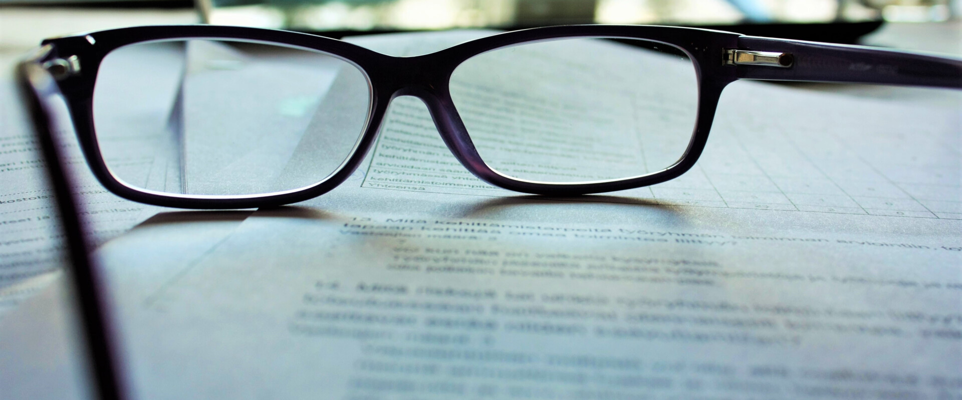 Glasses laying on top of physician statements